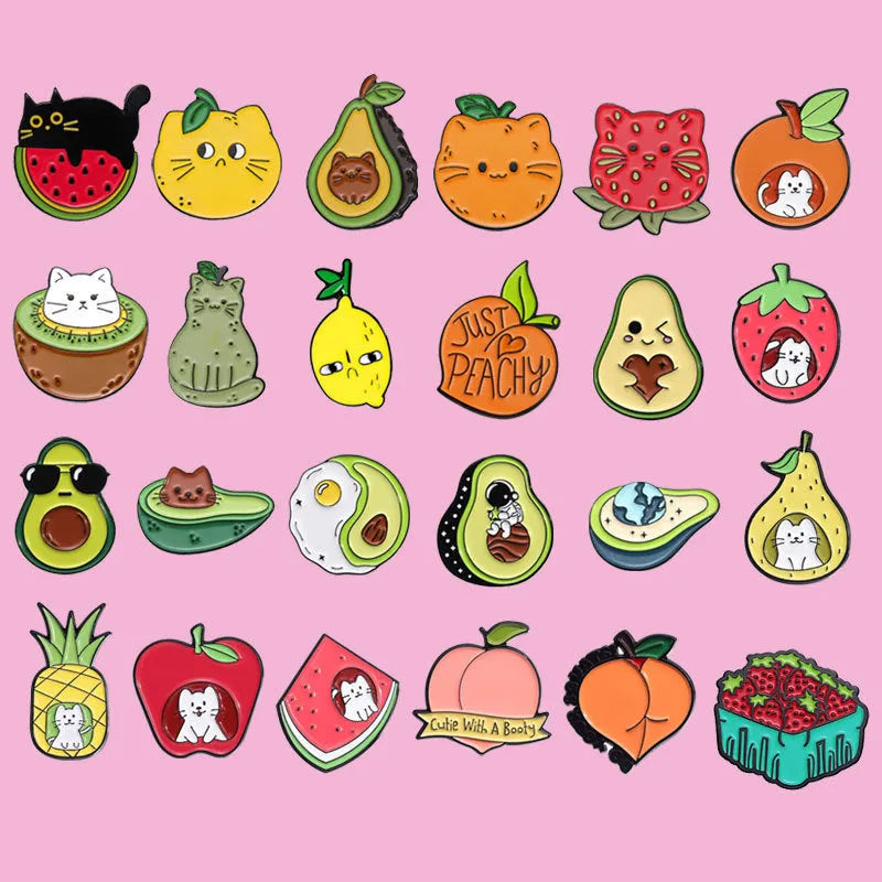 Colourful cartoon fruit design zinc alloy brooch pin on a fabric background.