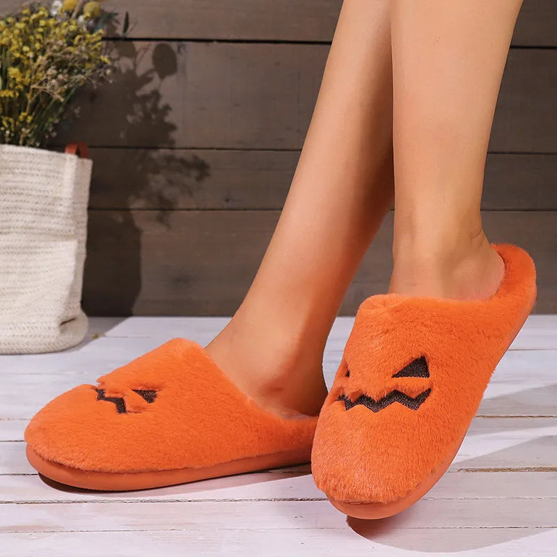 Orange coral velvet Halloween pumpkin-shaped slippers with a flat non-slip PVC sole and plush lining.