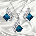 Women's necklace and ear stud set with alloy pendant, cross chain, and glass detailing in electroplated finish