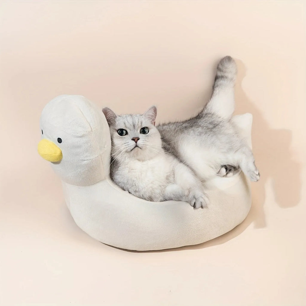 Blue duck-shaped fluffy pet bed sofa for small dogs and cats on a floor.