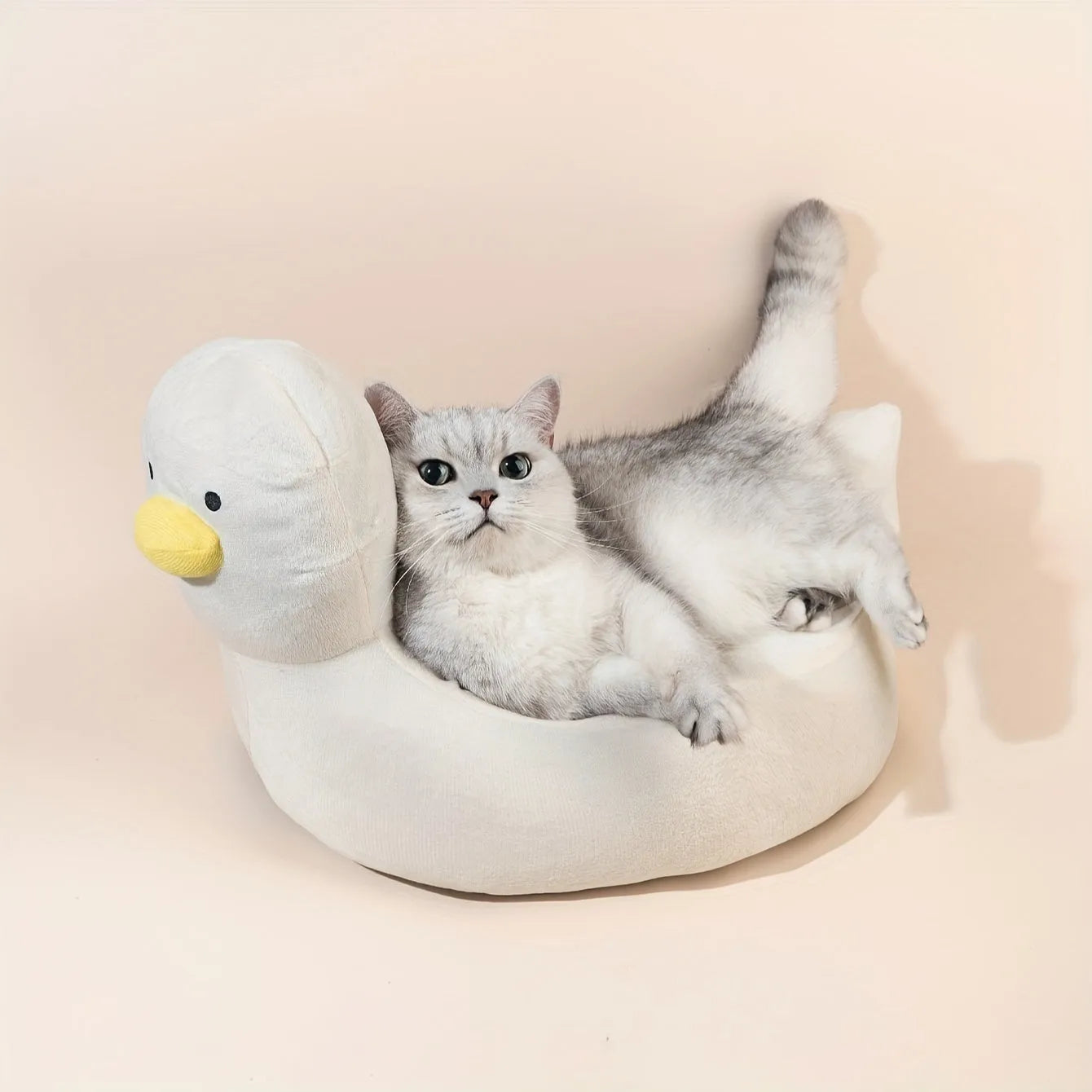 Blue duck-shaped fluffy pet bed sofa for small dogs and cats on a floor.