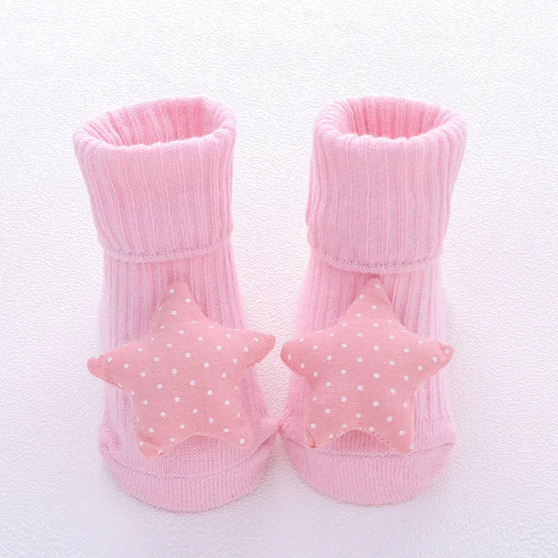 Cotton baby floor socks with non-slip soles in a pink bow print design.