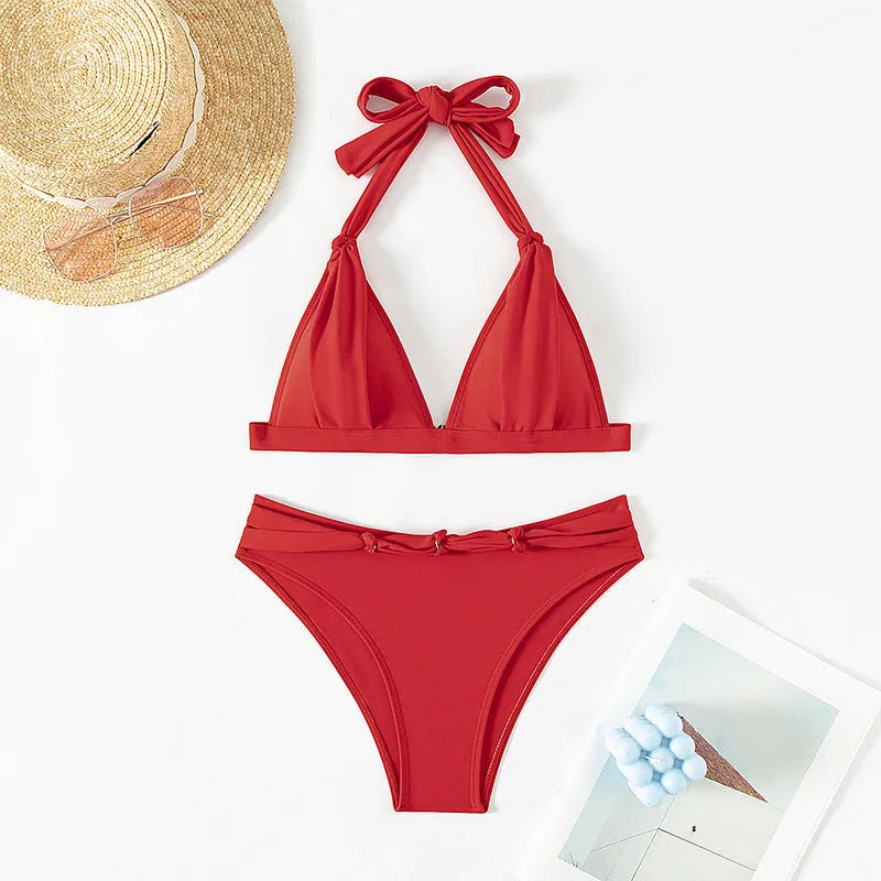 Red women's lace-up halterneck bikini set with separate shorts on a white background