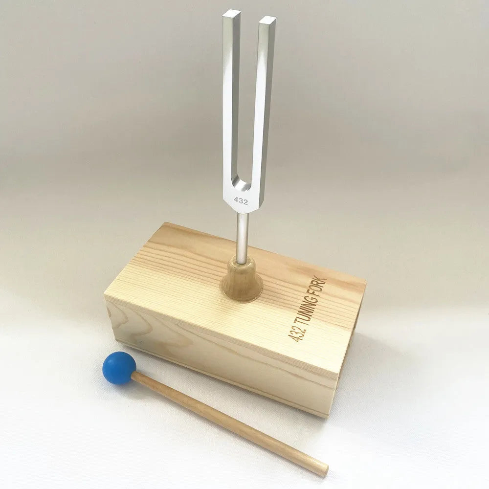 Aluminium alloy 432Hz tuning fork with connected speaker on kraft paper box