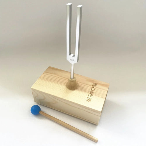 Aluminium alloy 432Hz tuning fork with connected speaker on kraft paper box