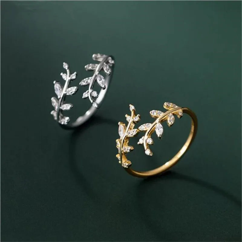Women's leaf design copper fashion ring with geometric elements and electroplated silver or gold finish