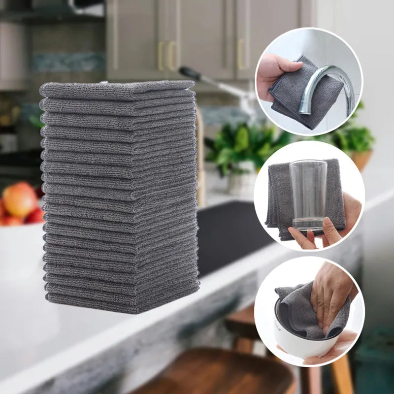 Grey square microfiber kitchen cleaning cloth for oil and grease removal on pots.
