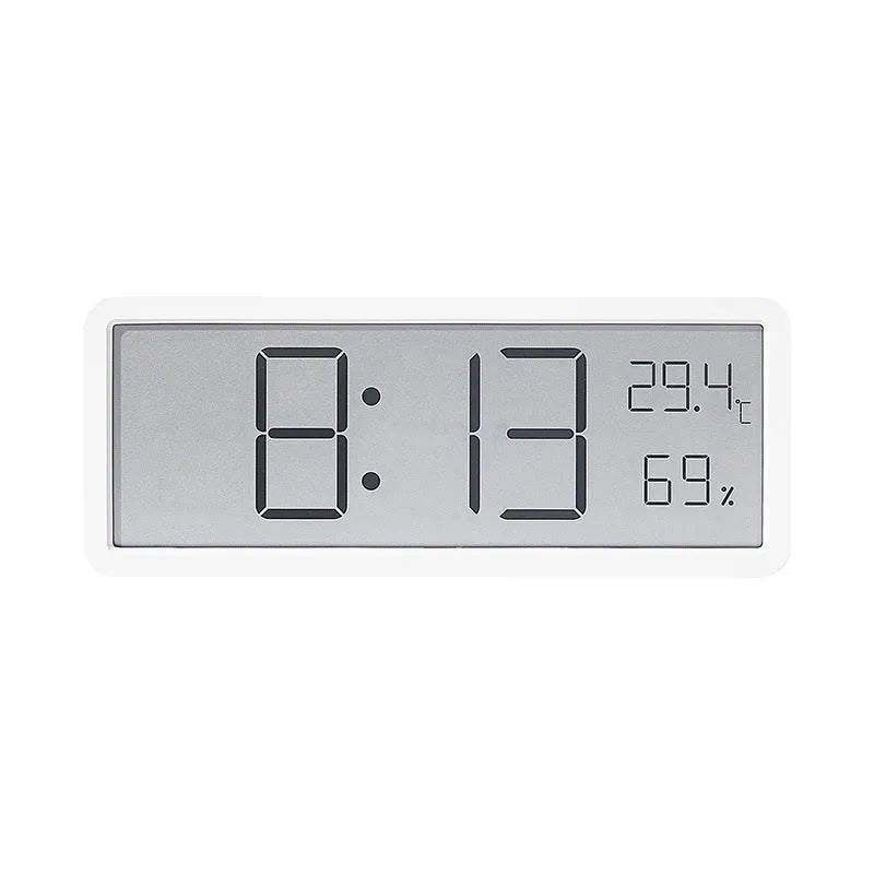 Simple large screen temperature and humidity clock in plastic with Nordic style, black colour, on a desk.