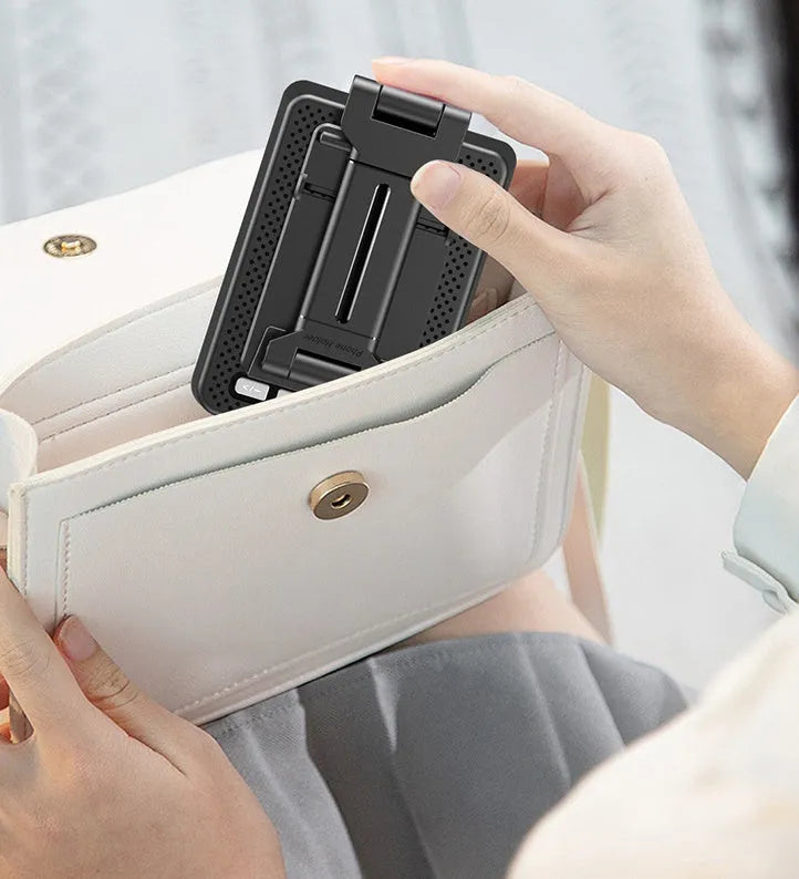 Black mobile phone broadcaster stand with wireless Bluetooth speaker and integrated HD microphone on desk