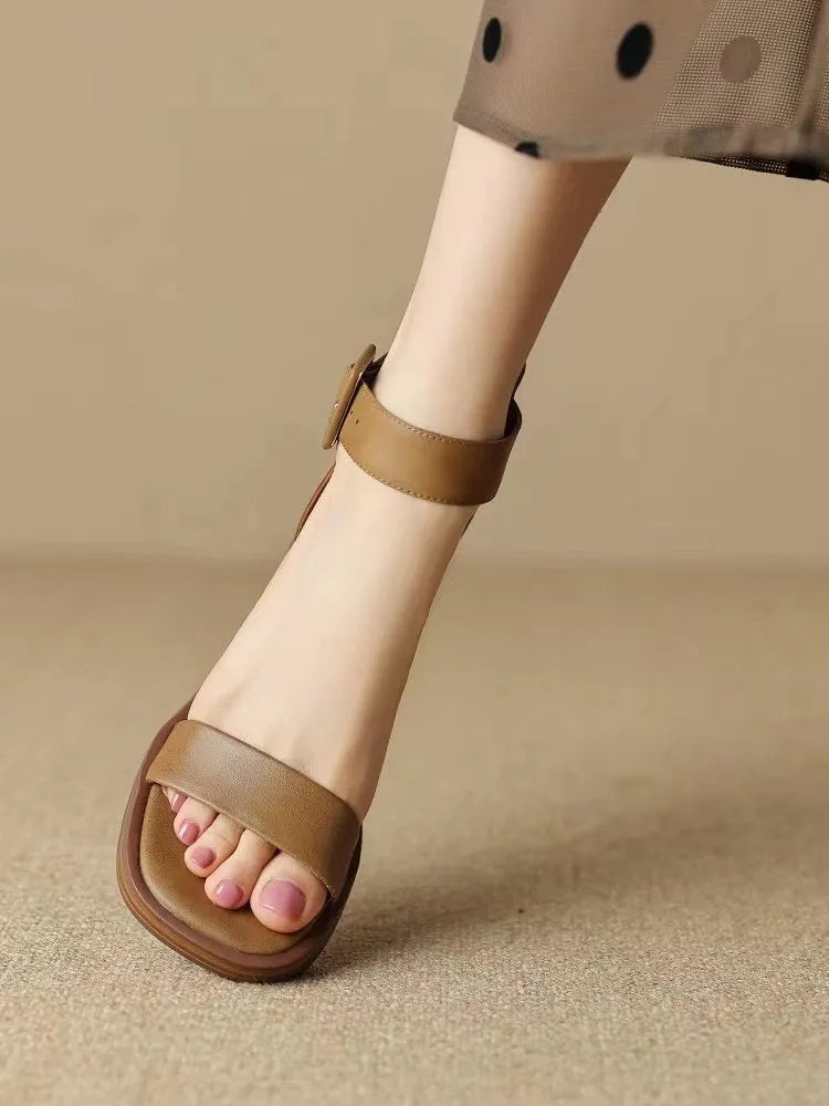 White women's platform high heels with an ankle strap and round toe on a plain background.