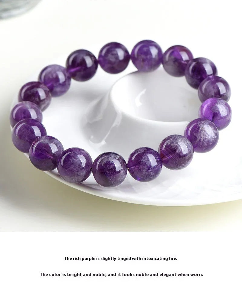 Natural feather amethyst bracelet with purple scattered beads and Ruyi design element.
