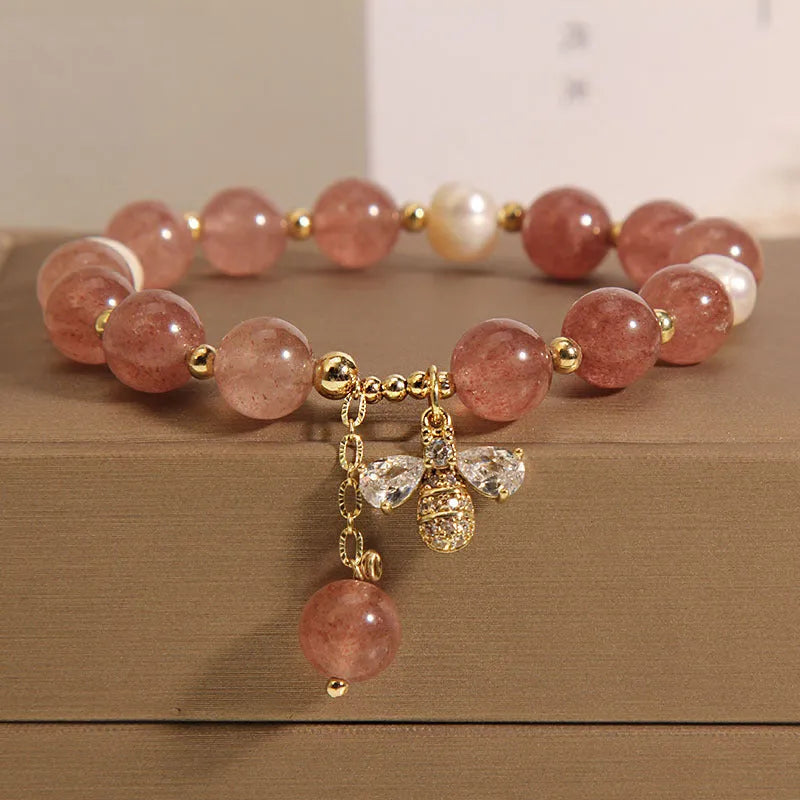 Women's bracelet with freshwater pearls, pink strawberry quartz stones, and a metallic zircon alloy clasp.