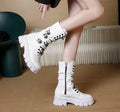 Women's black mid-calf knight boots with metal buckle and side zipper on a white background.