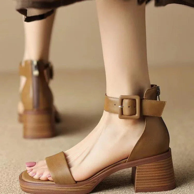 White women's platform high heels with an ankle strap and round toe on a plain background.