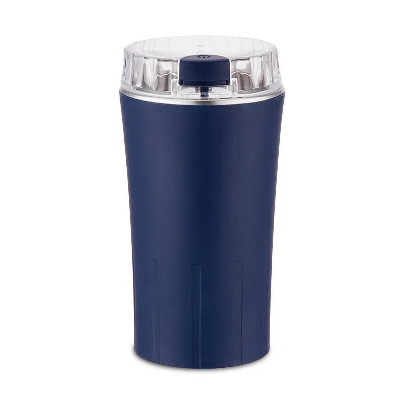 Blue mini flour mill and grain grinder appliance on a kitchen countertop.