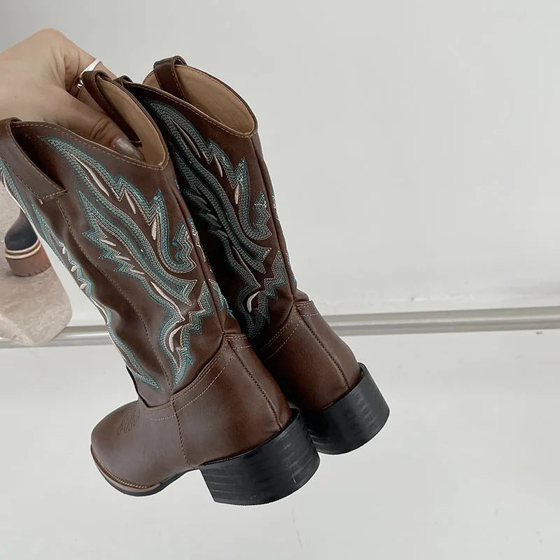 Brown women's mid-calf embroidered Martin boots with a leather lining and low rubber heel.
