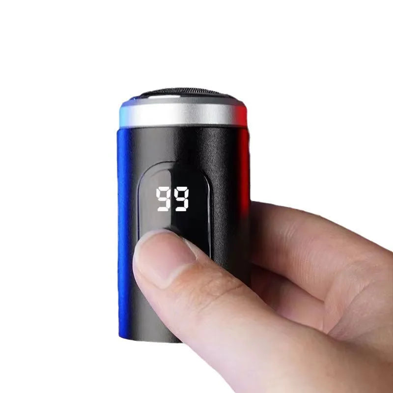 Black mini portable electric shaver with USB cable and cleaning brush on a white background.
