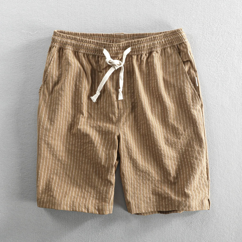 Men's striped casual shorts with elastic waistband in turmeric colour showing loose straight cut