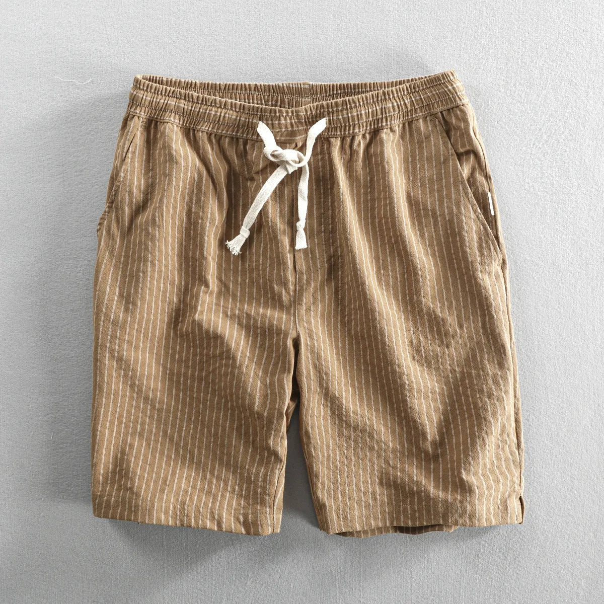 Men's striped casual shorts with elastic waistband in turmeric colour showing loose straight cut