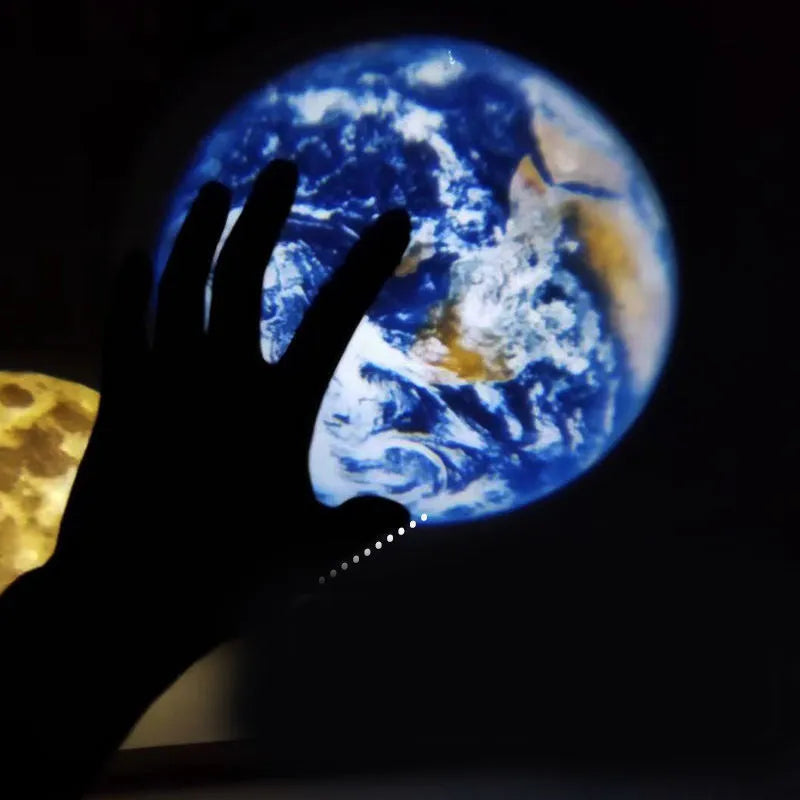 Earth and Moon star projection lamp with flexible hose bracket on a table