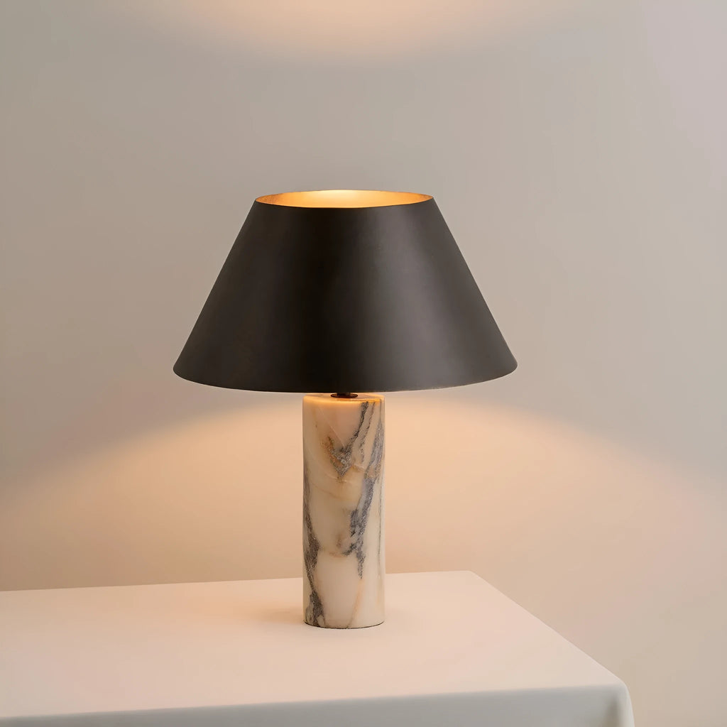 Black modern marble table lamp with minimalist design on wooden surface