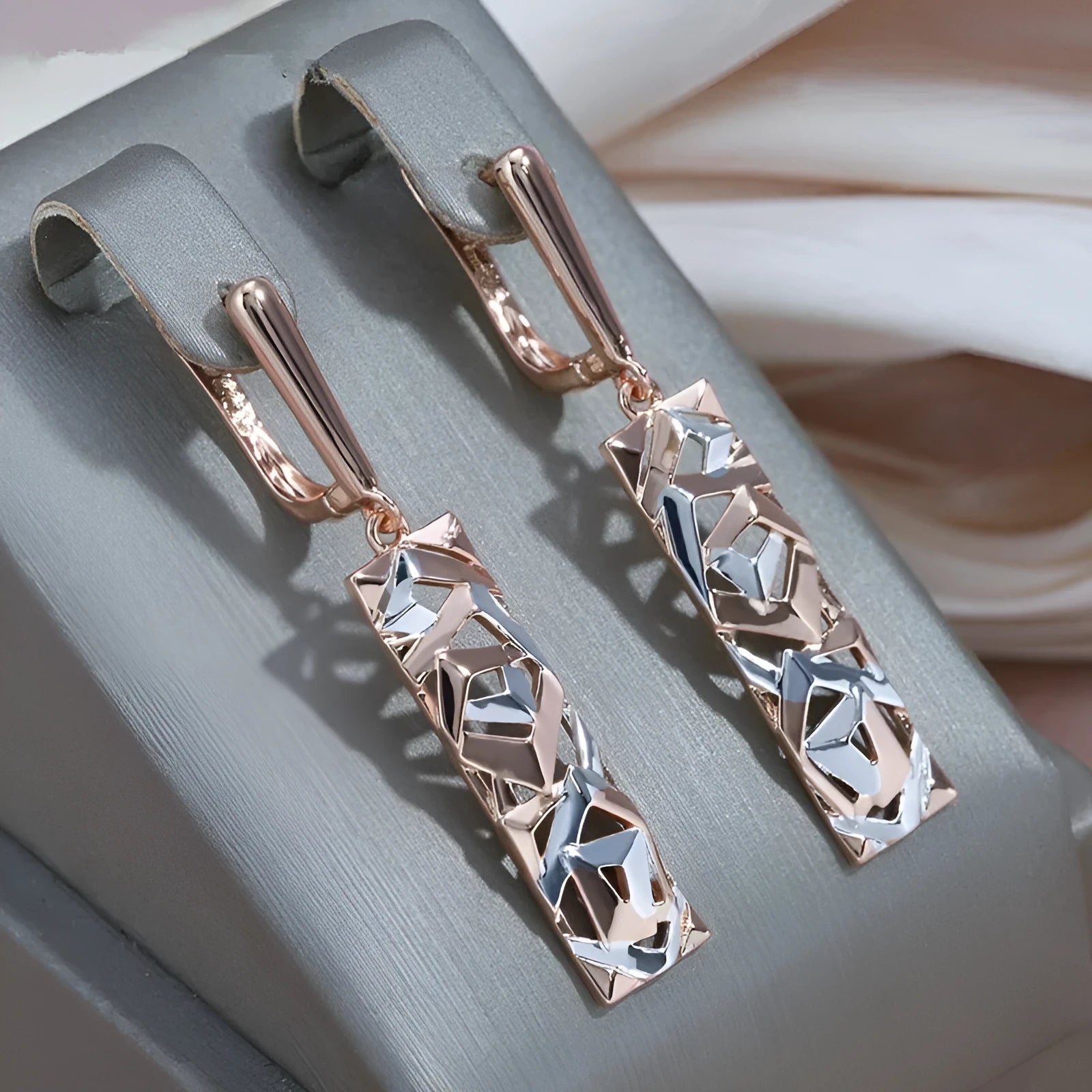 Rectangular two-tone hollow stud earrings for women with a geometric design and picture style finish.
