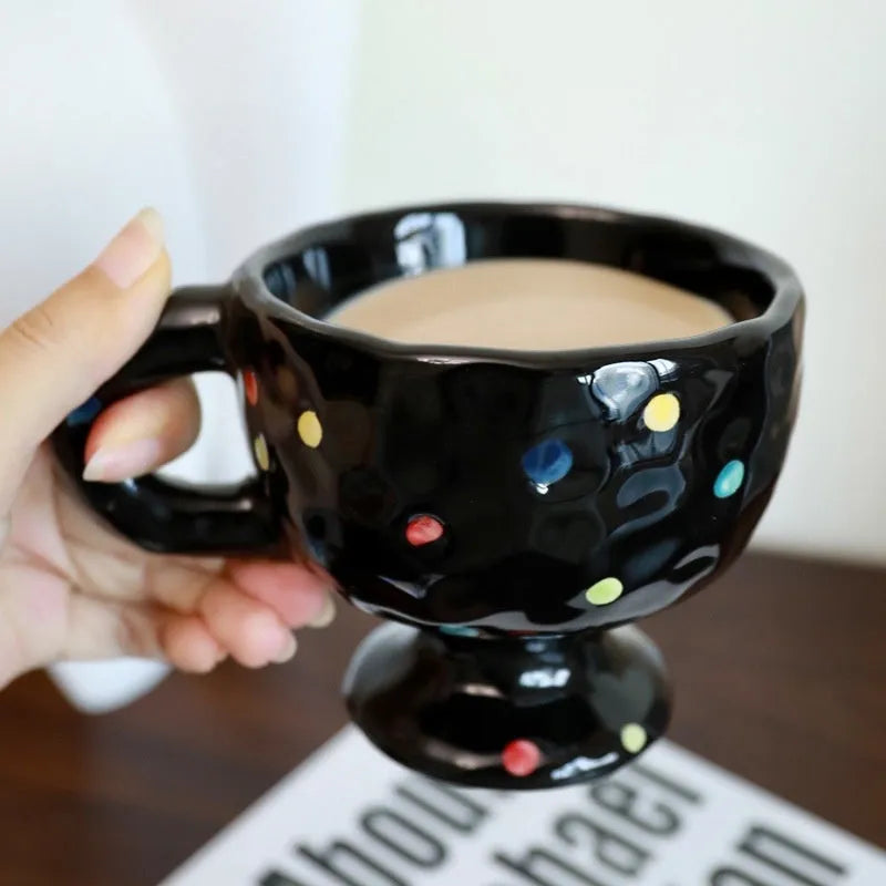Hand-pinched irregular shaped ceramic mug in a solid colour, modern simple design