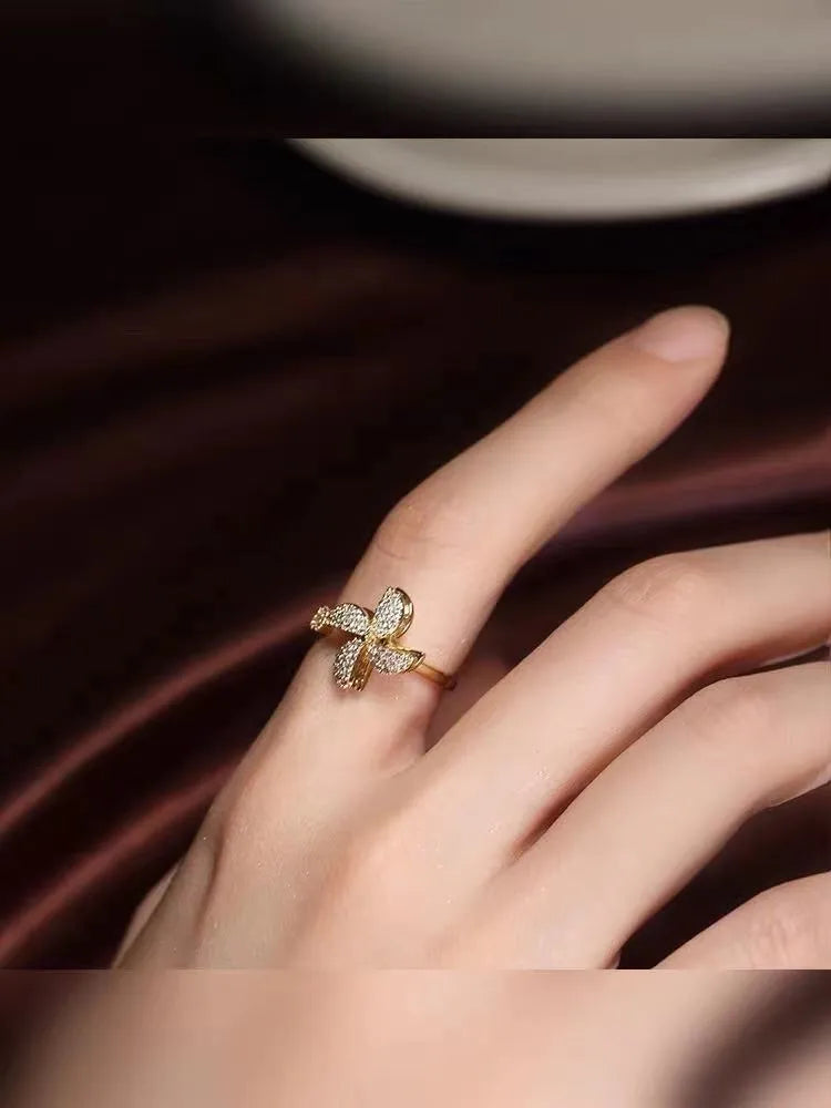 Gold and silver rotating ring with micro-inlaid geometric design on a copper band.