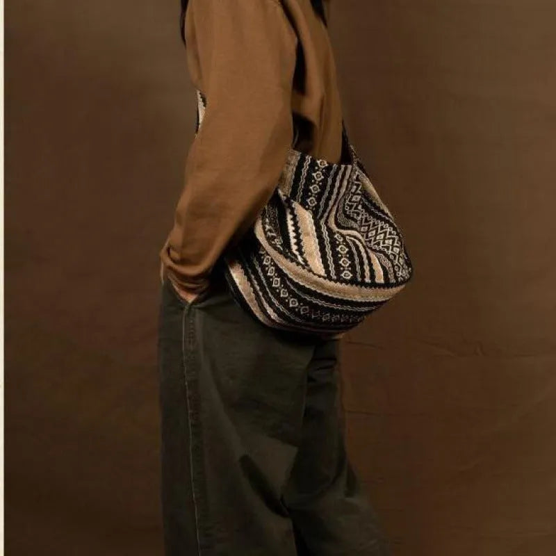 Retro striped corduroy messenger bag with jacquard detail and an adjustable plaid shoulder strap.