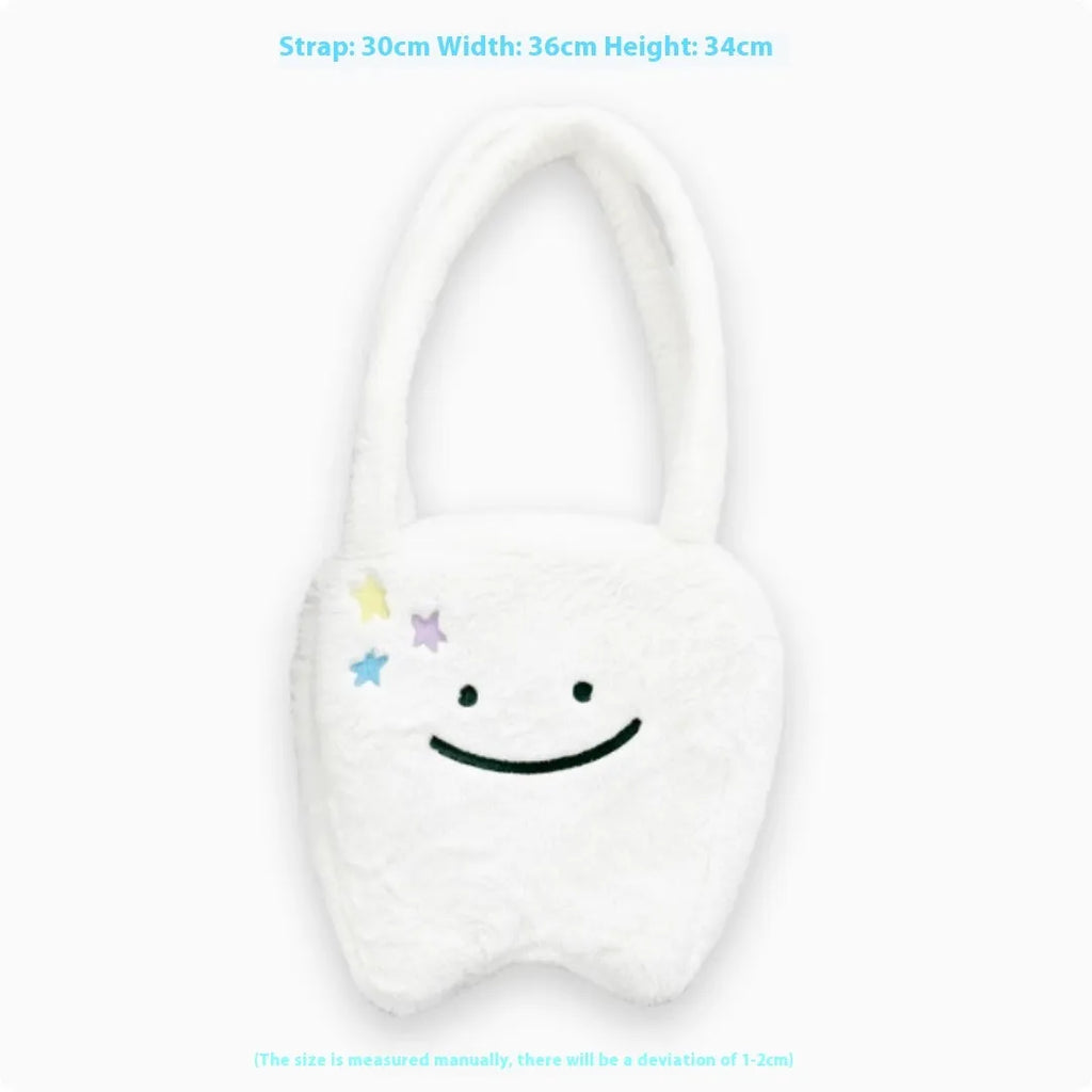 White plush large tooth shoulder tote bag with crossbody strap and zip closure.