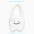 White plush large tooth shoulder tote bag with crossbody strap and zip closure.