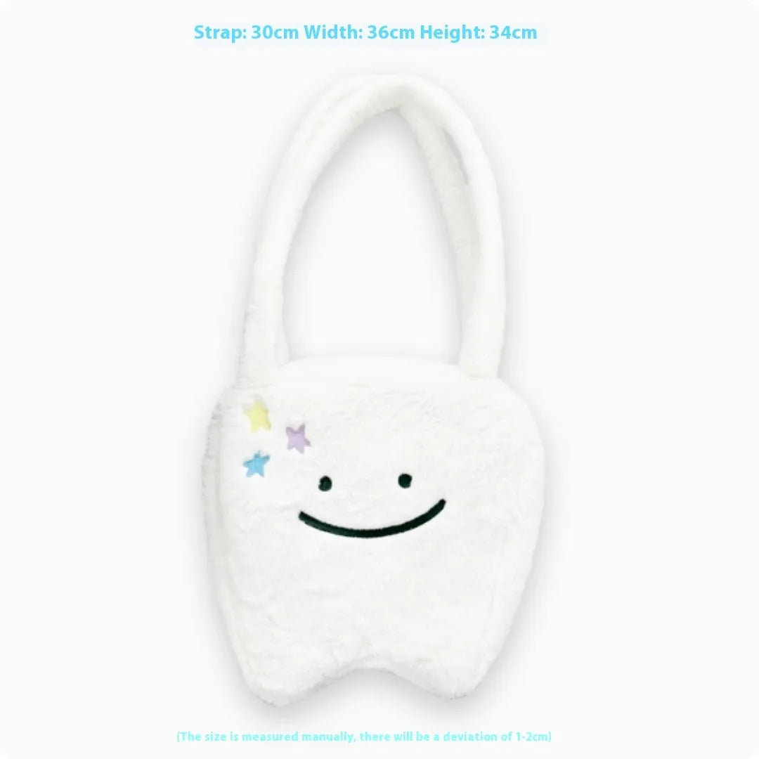 White plush large tooth shoulder tote bag with crossbody strap and zip closure.