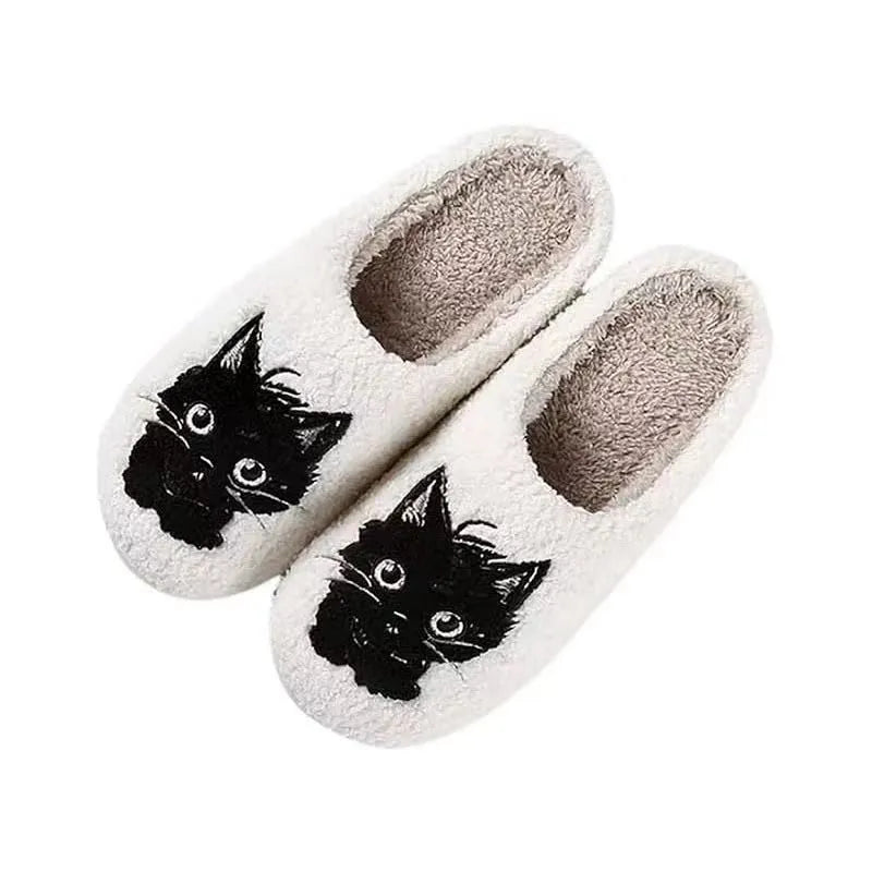 White plush couple slippers with black beard cat cartoon design and non-slip soles.