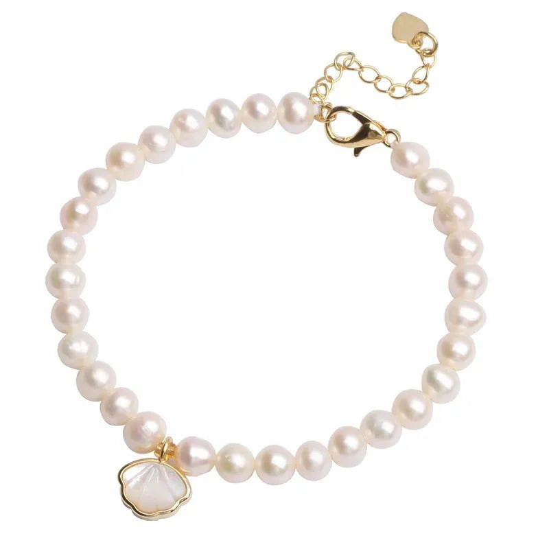 Close-up of a women's freshwater pearl bracelet with pearls arranged in a fan shape on a wrist.