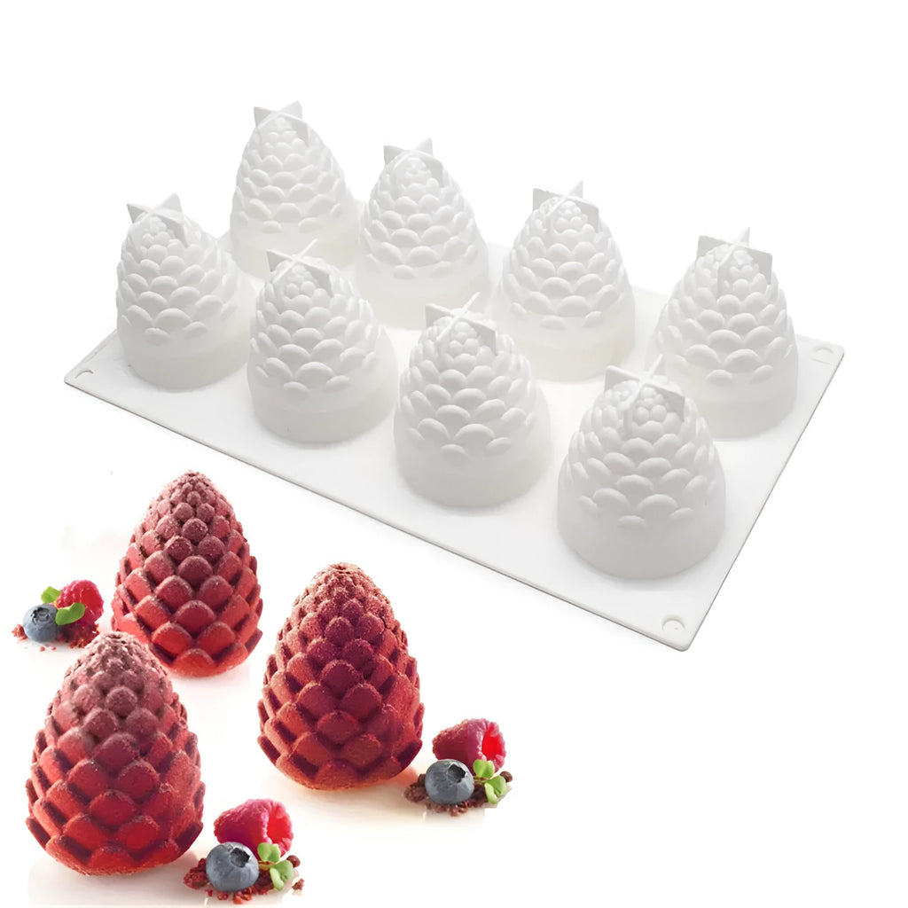 Silicone baking mould with six detailed pineapple and pine cone shaped cavities.