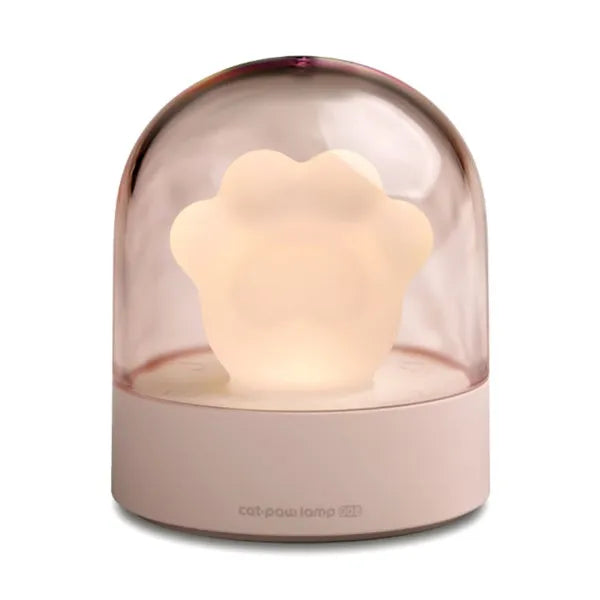 Grey cat paw shaped USB rechargeable night light with music box on a desk.