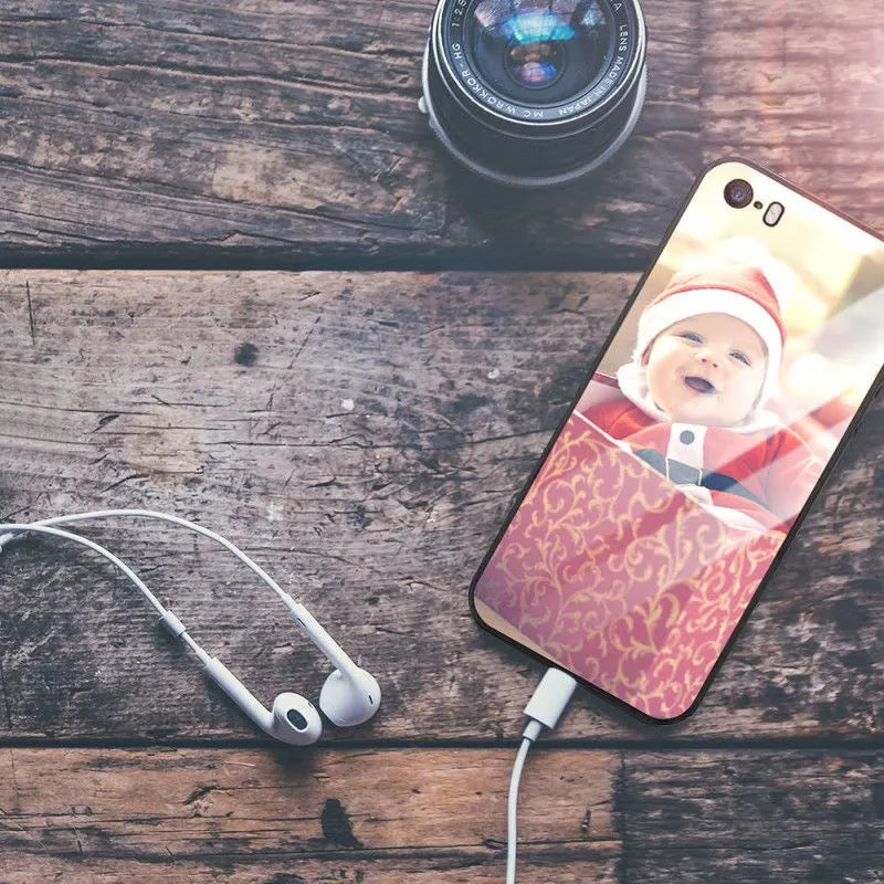 Patterned iPhone case with raised edges on a table next to an iPhone.