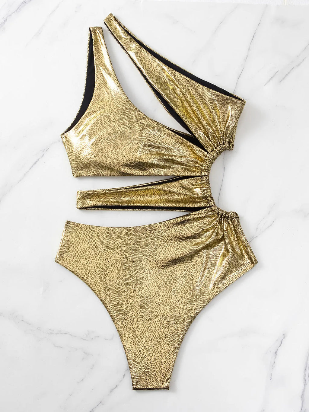 Gold women's backless one-piece swimsuit on a neutral background, showing sleeveless design.