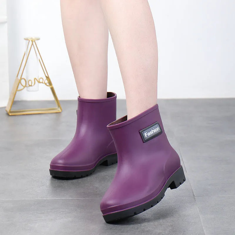 Women's mid-calf rain boot in PVC, low heel, shown in black colour.