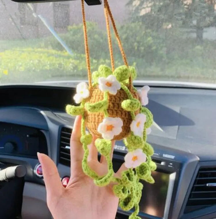 Green and white fish-scale style knitted wool car hanging planter with 8cm base and long white cord.