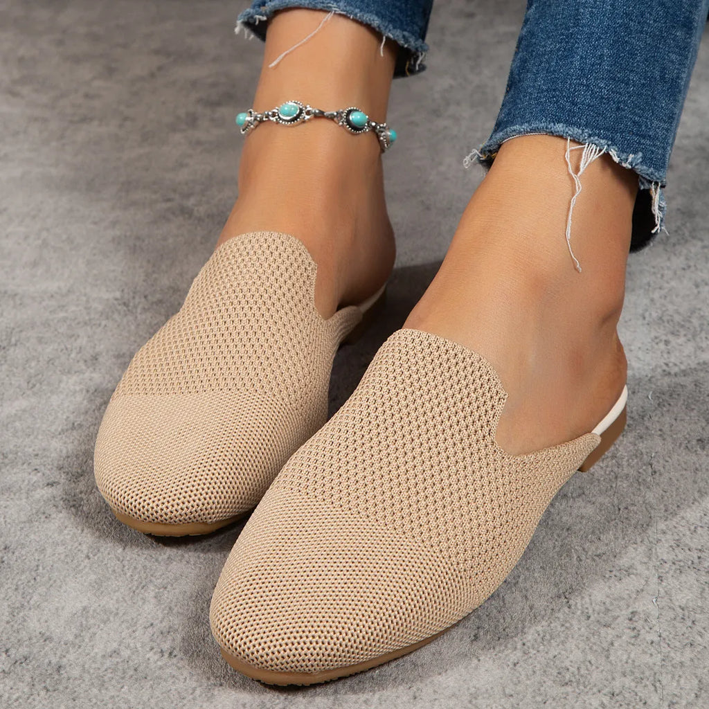 Apricot coloured mesh slip-on sandals with round toe and flat rubber sole on a white background.