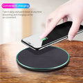 Black circular wireless charging pad for iPhone 11 with LED indicator light