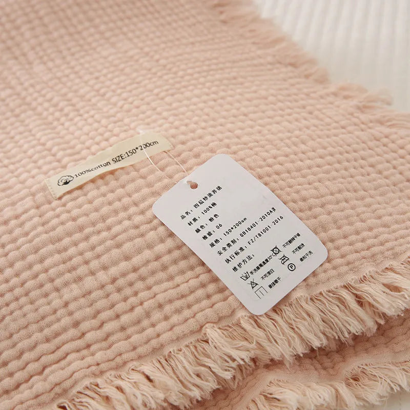 Four-layer gauze cotton blanket with tassel trim in a choice of ten colours and two sizes.