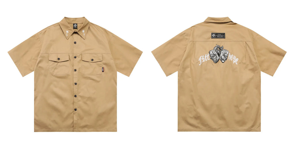 Men's loose fit black embroidered half-sleeve work shirt on a hanger.