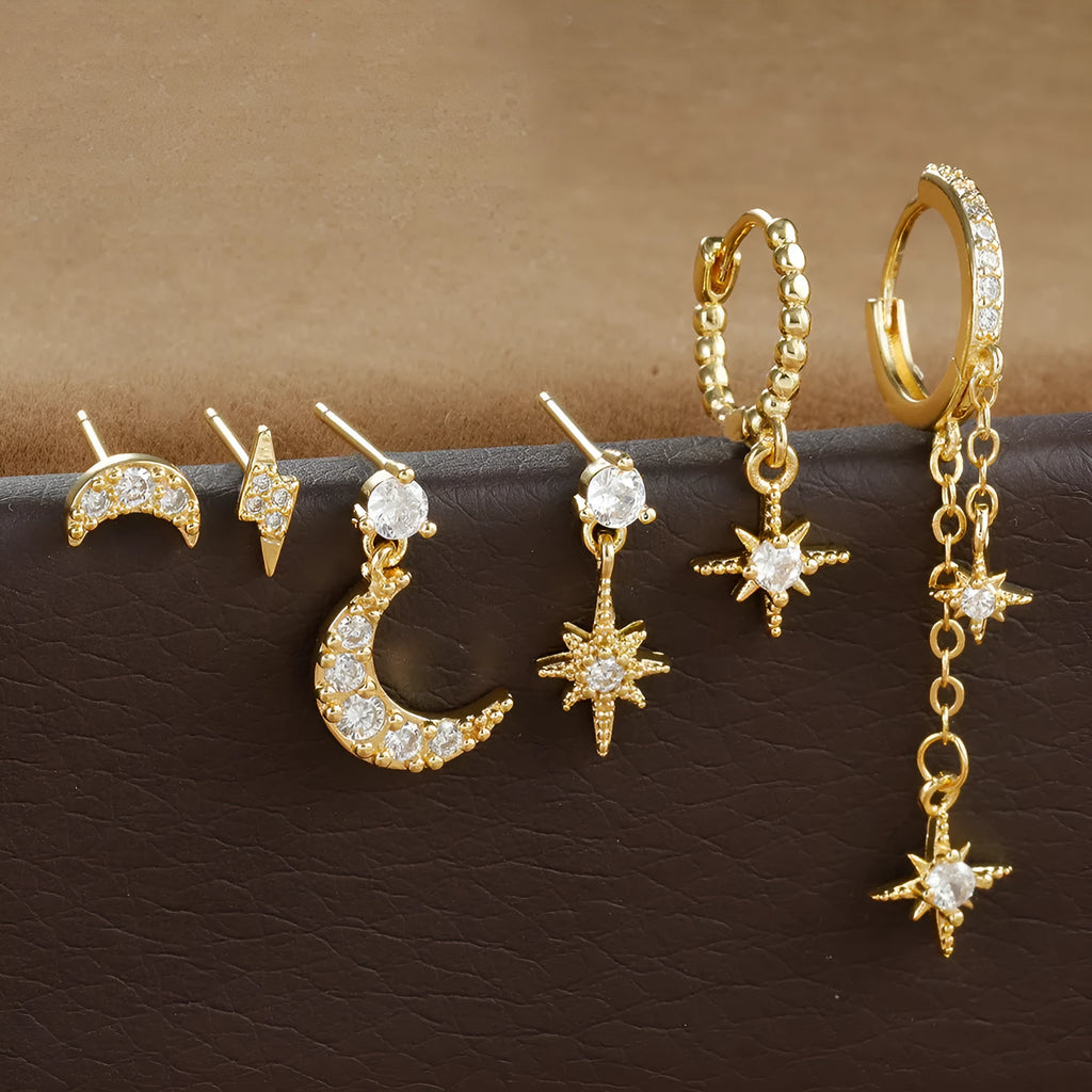 XINGX gold chain tassel earrings set with zircon stud accents, six individual pieces shown
