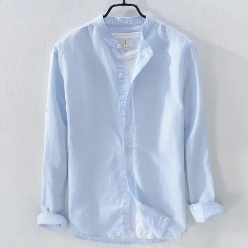A man wearing a loose-fitting long sleeve linen casual shirt in a solid colour.
