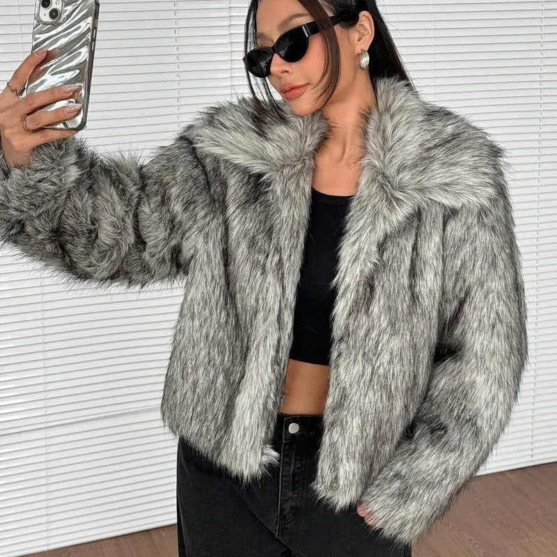 Women's short length artificial fur coat with a fur collar in a black tip on black background colour.