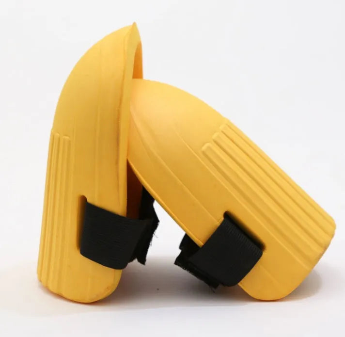 A pair of simple black EVA foam knee pads for gardening, showing their rectangular shape and thickness.