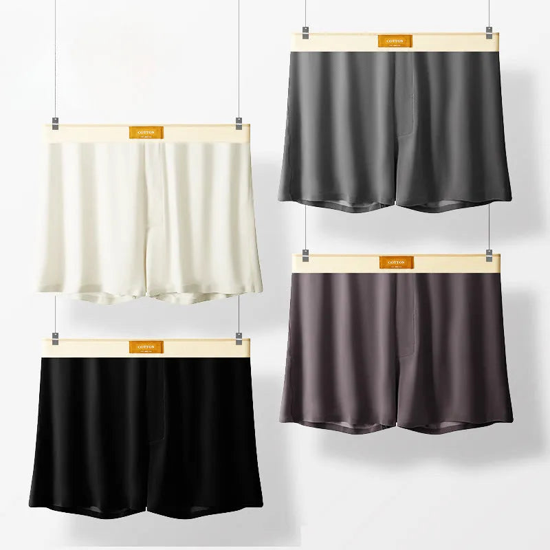 Pack of men's solid colour ice silk boxer shorts showing loose fit and mid-waist design.