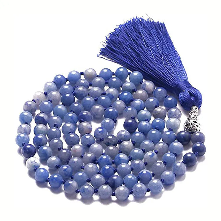 Long agate and amethyst gemstone tassel necklace with geometric pendant on a model.